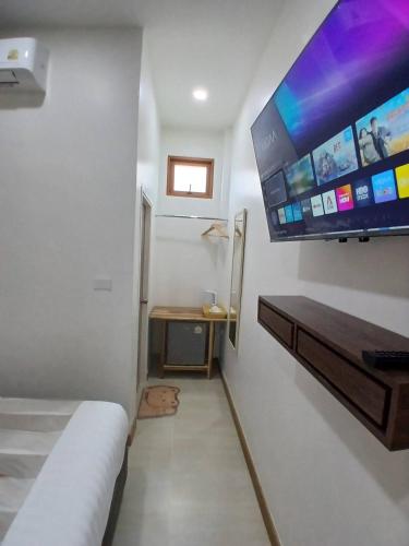 a room with a large flat screen tv on the wall at ศรีทองคูณ เชียงคาน ซอย4 in Chiang Khan
