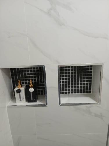 two bottles of soap sitting in the corner of a bathroom at ศรีทองคูณ เชียงคาน ซอย4 in Chiang Khan