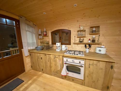 a kitchen with a stove top oven in a cabin at La champ être in Neuville-sur-Sarthe