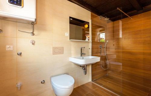 a bathroom with a toilet and a sink at Ferienhaus Nina mit Whirpool by Villas Guide in Selce