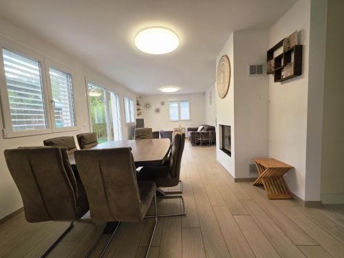 a dining room with a table and chairs at Charming family villa in Geneva