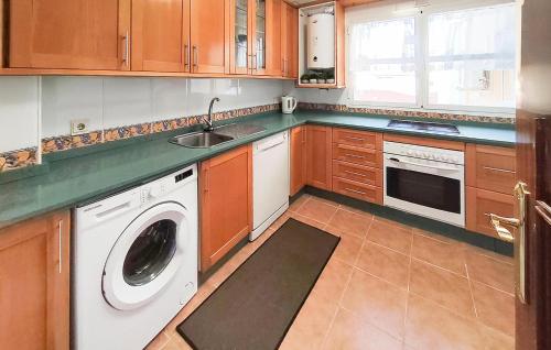 a kitchen with a washing machine and a sink at 3 Bedroom Gorgeous Apartment In Malaga in Málaga