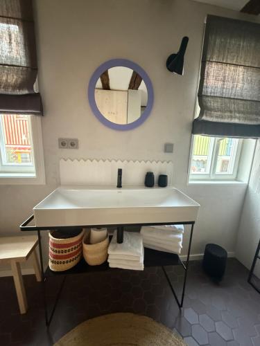 a bathroom with a sink and a mirror at Zur Traube - blau in Erbach im Odenwald