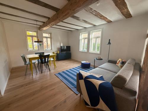 a living room with a couch and a table at Zur Traube - blau in Erbach im Odenwald