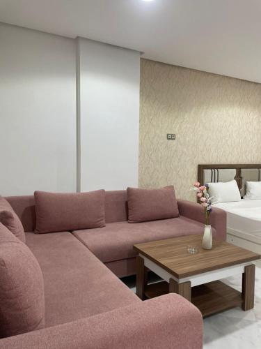 a living room with a couch and a table at Facelift in Tangier