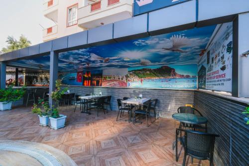 a patio of a restaurant with tables and chairs at Cleopatra King Apart in Alanya