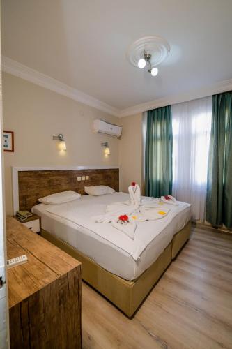 a bedroom with a large bed with flowers on it at Cleopatra King Apart in Alanya