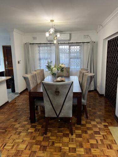 a dining room with a table and chairs at 8 on Lorenzo in Amanzimtoti