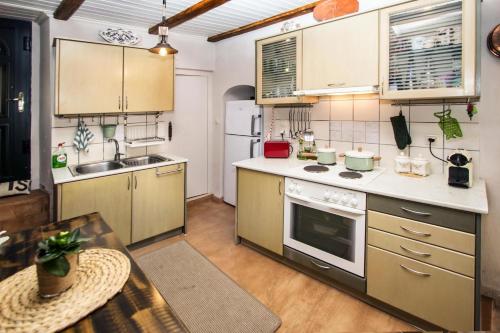 a kitchen with yellow cabinets and a stove top oven at Victor's Traditional House in Chlomós