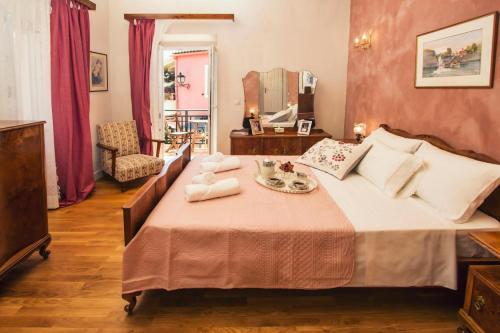 a bedroom with a large bed with a tray of food on it at Victor's Traditional House in Chlomós