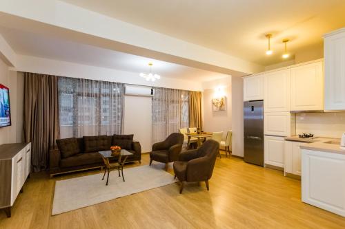 a living room with a couch and a table at Central Elegant Apartment in Tbilisi City