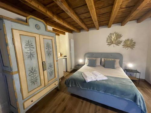 a bedroom with a bed in a room with wooden ceilings at Rota's House in Bergamo