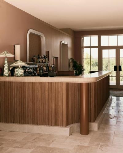 a lobby with a bar with mirrors on the wall at Repère Sauvage, Hôtel Lodges & Restaurant in La Ville-aux-Clercs