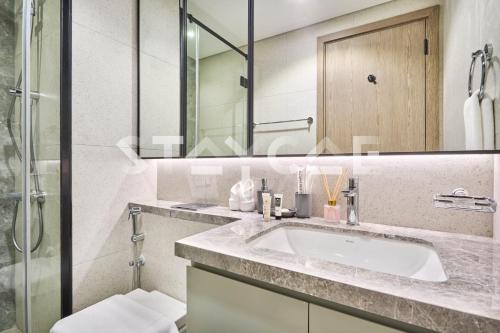 a bathroom with a sink and a shower at Staycae Holiday Homes Golf Gate - Damac Hills in Dubai