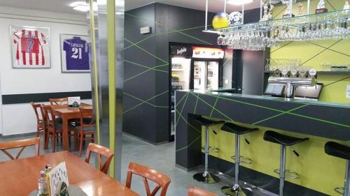 a restaurant with a bar and some tables and chairs at Sport centrum na hřišti in Golčŭv Jeníkov