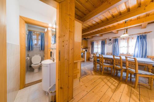 a kitchen and dining room with a table and chairs and a kitchen andheasternheastern at Baďurky in Velké Karlovice