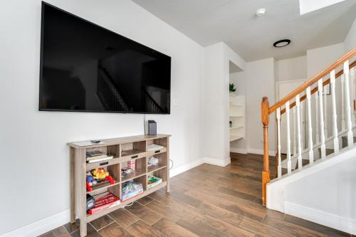 a living room with a large flat screen tv on a wall at Fabulous & Stylish 4BR w Pool Table and Space to Chill in Houston