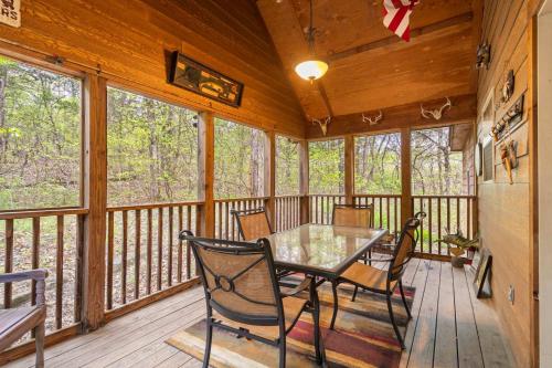 a dining room with a table and chairs on a deck at Simon's Treetop Cabin - 2 BDR in Popular Resort in Branson West