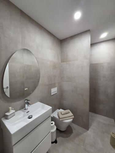 a bathroom with a sink and a toilet and a mirror at Gardel Esencia in Icod de los Vinos