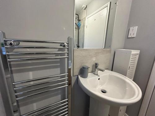 a bathroom with a sink and a mirror at 3 Bedroom, Parking, 2 Toilets, Wi-Fi, Modern in Crewe