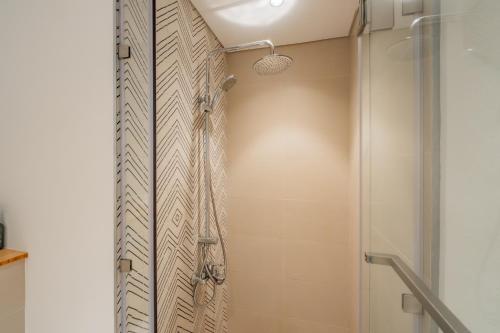a bathroom with a shower with a glass door at Elite Escapes - Socio Stylish 1 BHK Getaway in Dubai