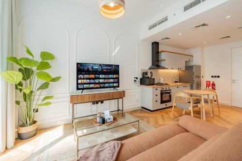 a living room with a couch and a table at Elite Escapes - Socio Stylish 1 BHK Getaway in Dubai