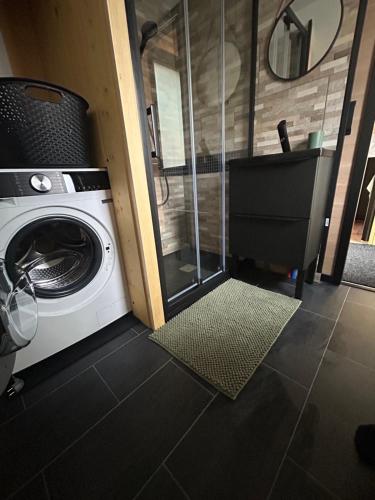 a washer and dryer in a tiny house at L Atypique in Saint-Éloi