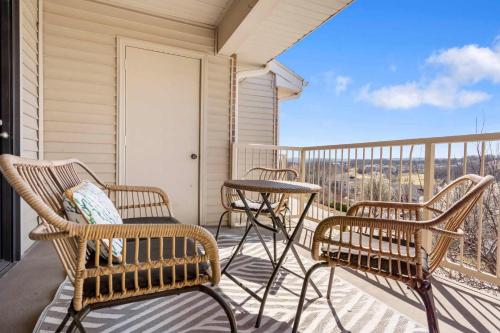 a balcony with three chairs and a table and a view at Great Escape Duo in Branson