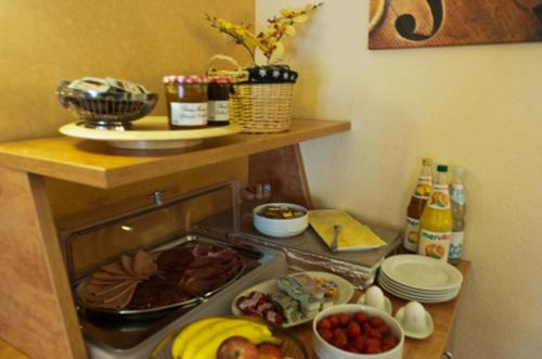 a kitchen with a counter with food on the stove at Hotel Perler Hof in Perl
