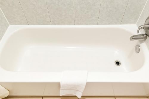 a white bath tub with a roll of toilet paper at Relax Inn by OYO Sulphur Hwy 90 in Sulphur