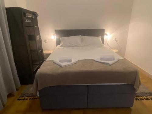 a bedroom with a large bed with two towels on it at Ganzha Appart in Medulin
