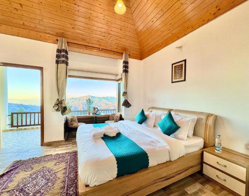 a bedroom with a large bed with a large window at The Kufri Mansion I Three-Bedroom Villa l by Exotic Stays in Kūfrī