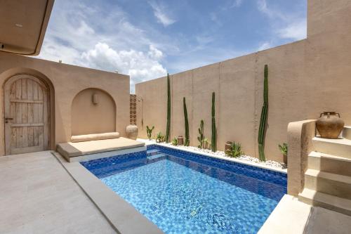 a swimming pool in the middle of a house at Pasir 2 - A stylish 2 bed villa in Bingin w pool in Bingin Beach