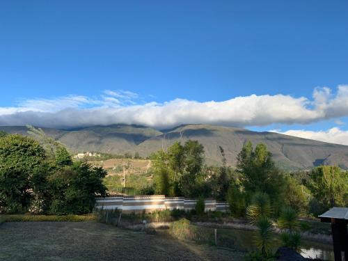 a view of a mountain range with clouds in the sky at Hacienda Cascanueces in Villa de Leyva