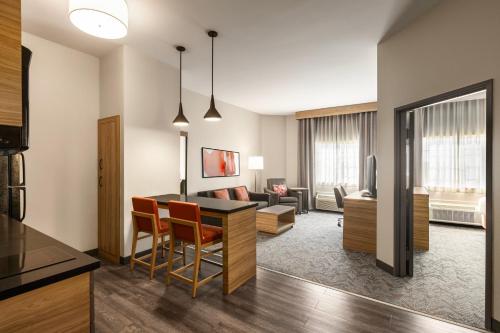 a living room with a kitchen and a dining room at Candlewood Suites Loveland by IHG in Loveland