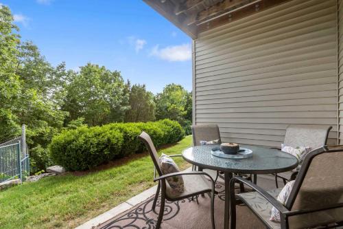 a patio with a table and chairs on a porch at Blue Heron Hideaway - Table Rock Lake in Branson