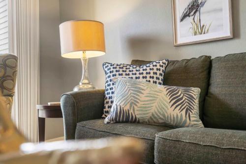 a living room with a couch and a lamp at Blue Heron Hideaway - Table Rock Lake in Branson