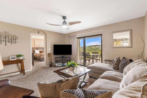 a living room with a couch and a table at Golf Course View at the Foothills Resort in Branson
