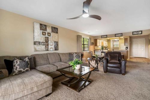 a living room with a couch and a table at Golf Course View at the Foothills Resort in Branson