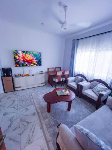 a living room with two couches and a table at the cozy lookout in Malindi