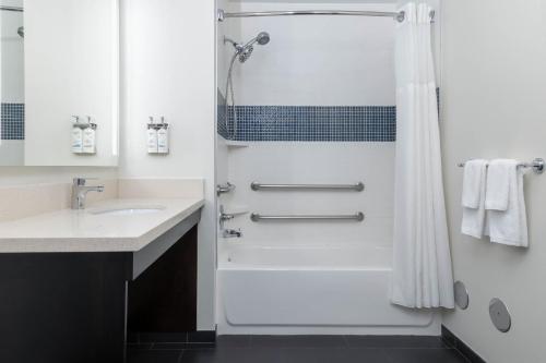 a bathroom with a shower and a sink at Staybridge Suites Chandler by IHG in Chandler