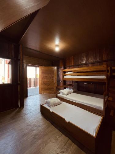 two bunk beds in a room with wooden walls at Casa de Praia Tribo de Judá in Bragança
