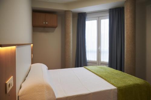 En eller flere senge i et værelse på Pensión CasaBlanca