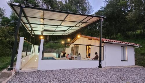 a view of a house with a large glass extension at Manawa Kaona in Somondoco