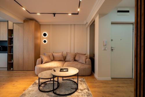 a living room with a couch and a table at Ivory Garden Retreat by Blvd 63B3 in Bucharest