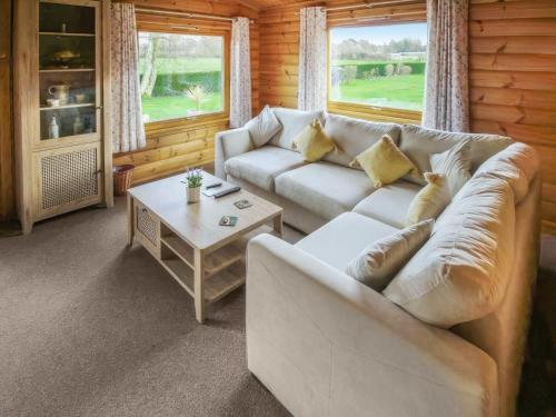 a living room with a couch and a coffee table at The Lodge in Storrington
