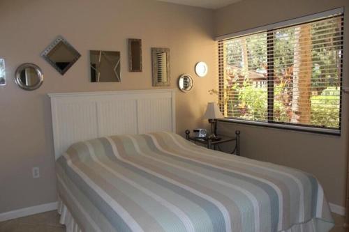 a bedroom with a large bed and a window at Midnight Cove II 117F in Siesta Key