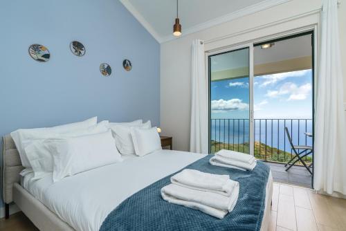 a bedroom with a bed with towels on it at Villa Pargo Green by Madeira Dream Stays in Ponta do Pargo