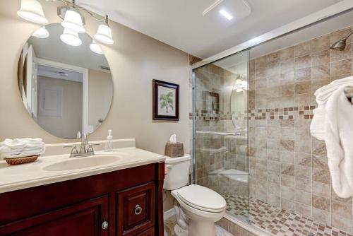 a bathroom with a toilet and a sink and a shower at Midnight Cove II 134F in Siesta Key