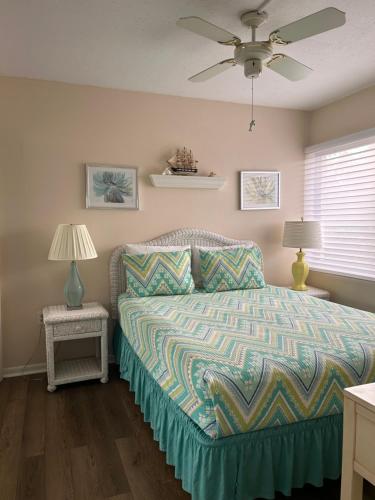 a bedroom with a bed and a ceiling fan at Midnight Cove II 211F in Siesta Key